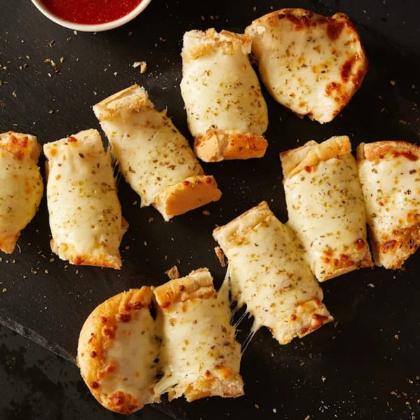 Cheesy garlic breadsticks with herbs and melted mozzarella, served with a side of marinara sauce.